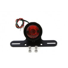 12 volt tail Lamp is bulb type with black rim and includes a black bracket for universal mounting.